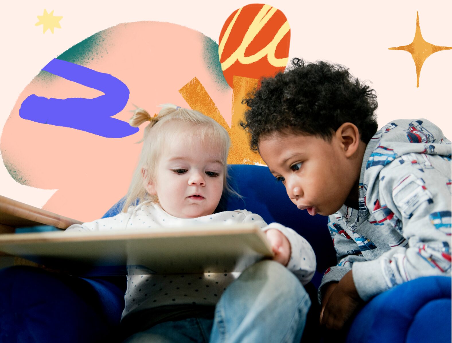 Two young children reading a book together